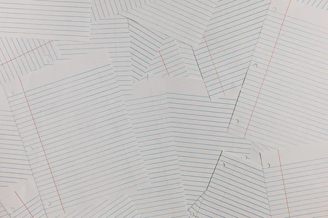 Overhead view of scattered blank lined paper sheets creating a textured background. Rolling back a workflow without replaying completed actions
