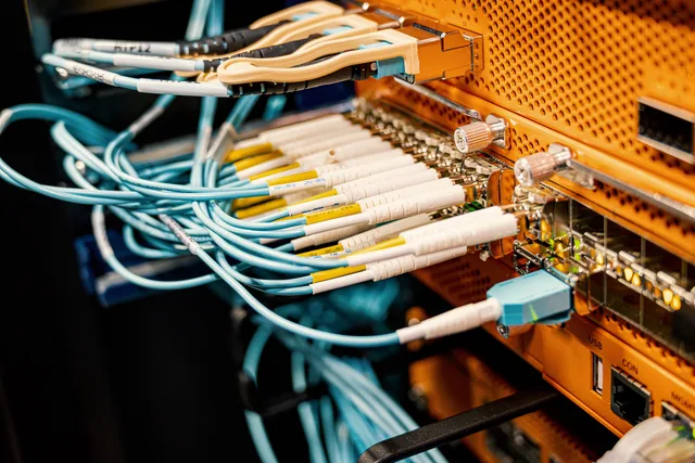Modern hardware and structured cabling system with patch cords inserted into patch panel outlets. Rotating credentials without breaking scheduled workflows